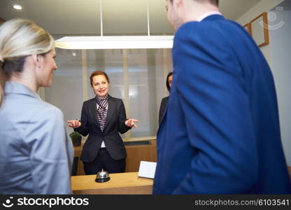 Couple on a business trip doing check-in at the hotel