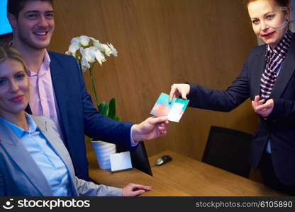 Couple on a business trip doing check-in at the hotel