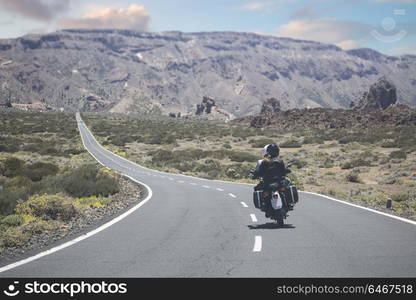 couple on a motorcycle traveling in the mountains