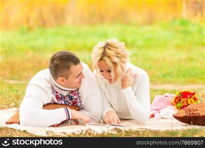 couple on a picnic together reading a novel