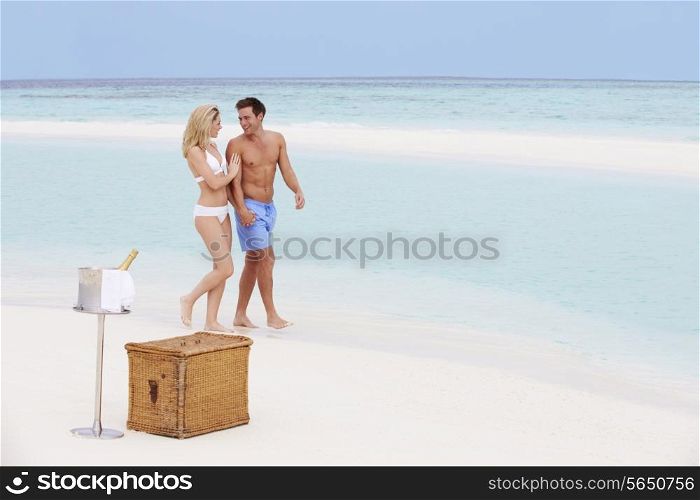 Couple On Beach With Luxury Champagne Picnic