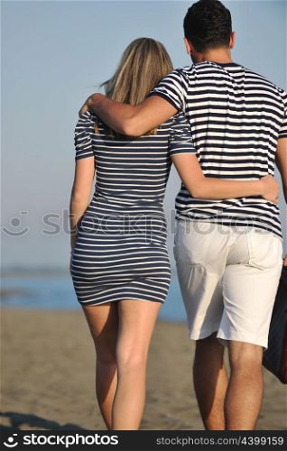couple on beach with travel bag representing freedom and funy honeymoon concept