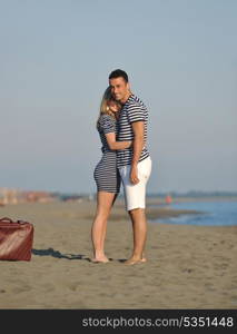 couple on beach with travel bag representing freedom and funy honeymoon concept