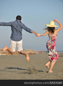 couple on beach with travel bag representing freedom and funy honeymoon concept