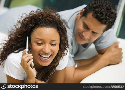 Couple on Boat Using Cell Phone