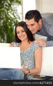 Couple on couch with computer