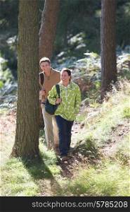 Couple On Country Walk Through Woodland