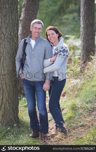 Couple On Country Walk Through Woodland