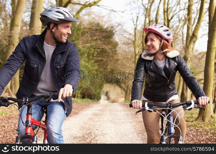 Couple On Cycle Ride In Winter Countryside