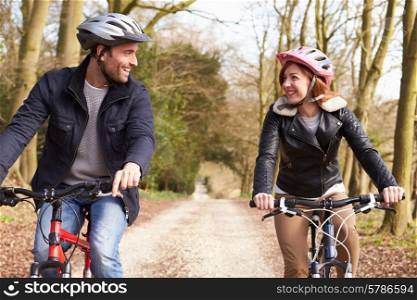 Couple On Cycle Ride In Winter Countryside