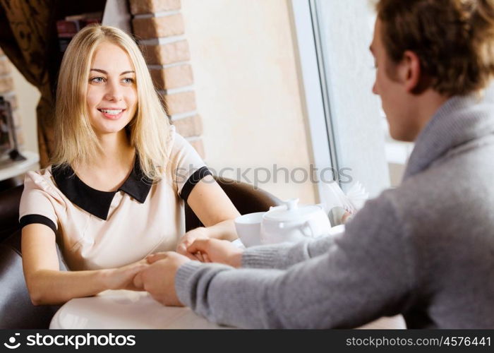 Couple on date. Young attractive lady having date at cafe