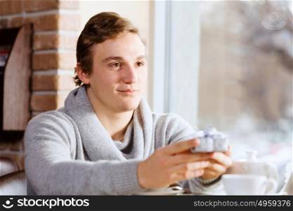 Couple on date. Young man at date giving box with present to his girl