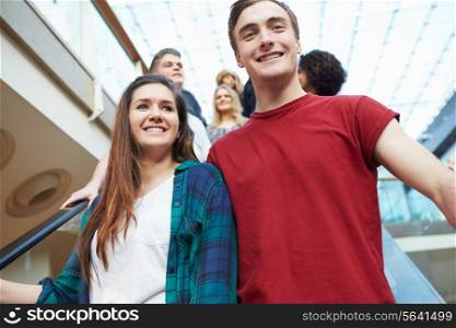 Couple On Escalator In Shopping Mall Together