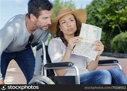 couple on holiday disabled woman holding map