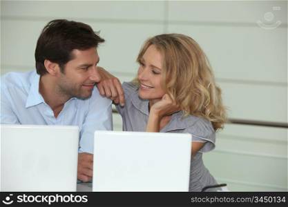 Couple on laptops