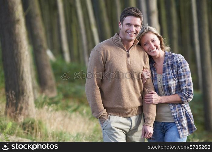 Couple On Romantic Country Walk Through Woodland