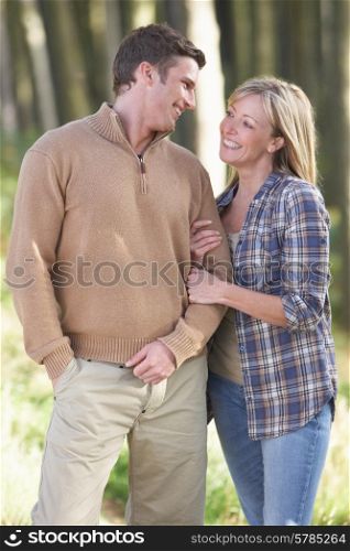 Couple On Romantic Country Walk Through Woodland