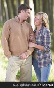 Couple On Romantic Country Walk Through Woodland