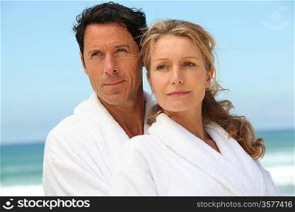 Couple on the beach in white dressing downs