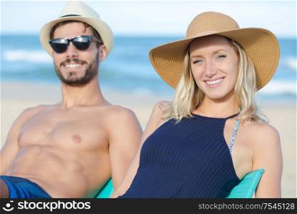 couple on the beach sunbathing