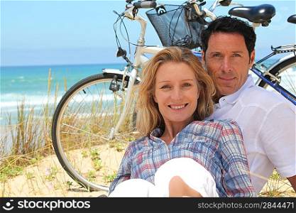 couple on the beach with bikes