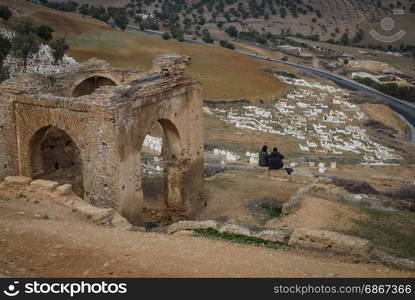 Couple on the hill over the cementery Fez, Morocco North Africa. Muslim cemetery graves. Fez, Morocco North Africa