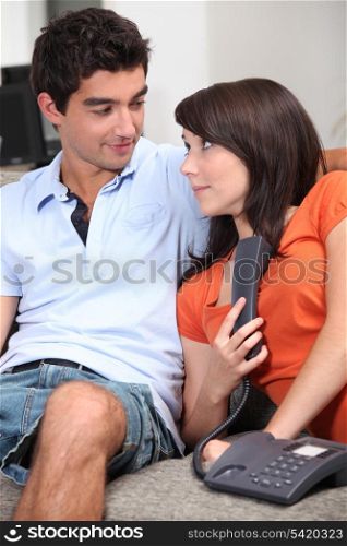 Couple on the sofa with a telephone