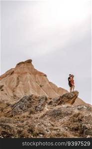 Couple on top of a rock on a desertic landscape on the Barcenas Reales desert in Navarra, Spain