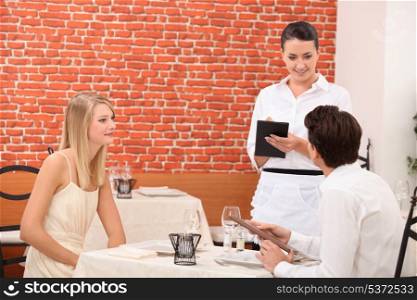 Couple ordering food in restaurant