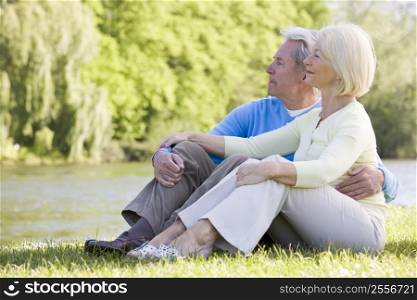 Couple outdoors at park by lake