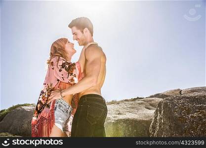 Couple outdoors, face to face, smiling