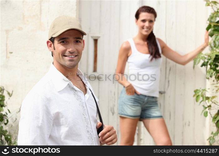 Couple outside a house in the summer