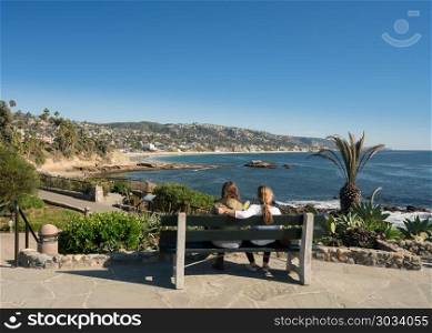Couple overlook coastline at Laguna Beach. Mother and daughter look at view from Recreation Point Laguna Beach in California. Couple overlook coastline at Laguna Beach