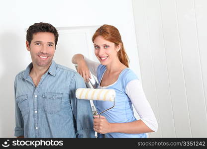 Couple painting new apartment