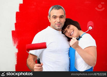 Couple painting wall red