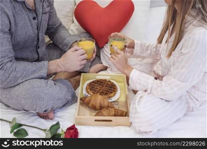 couple pajamas drinking juice bed
