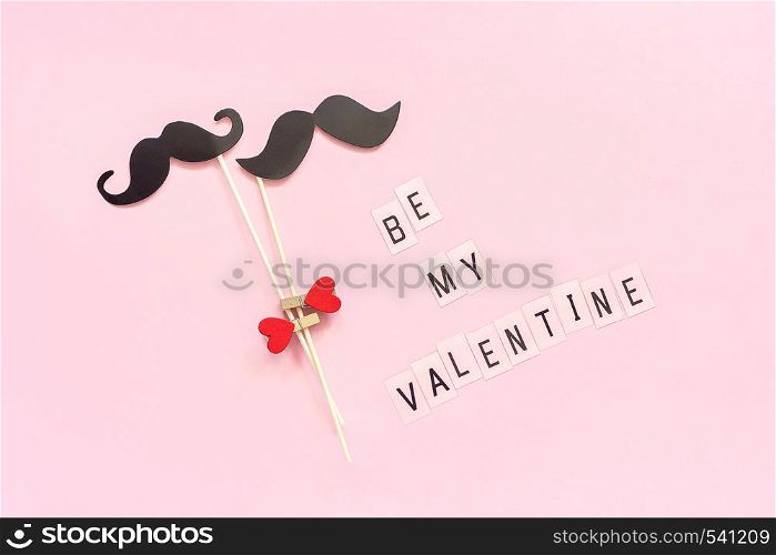 Couple paper mustache props on stick fastened clothespin heart and text Be my Valentine on pink background Concept Homosexuality gay love. Valentine's Day, Valentine card Creative Top view.. Couple paper mustache props on stick fastened clothespin heart and text Be my Valentine on pink background Concept Homosexuality gay love. Valentine's Day, Valentine card Creative Top view