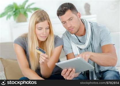 Couple paying with credit card on the internet