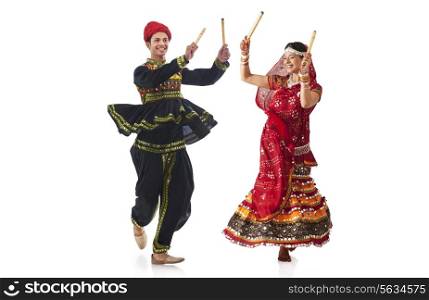 Couple performing dandia dance