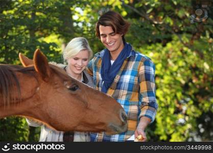 Couple petting horse