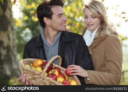 Couple picking apples