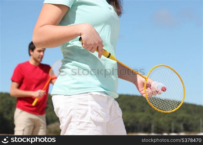 Couple playing badminton