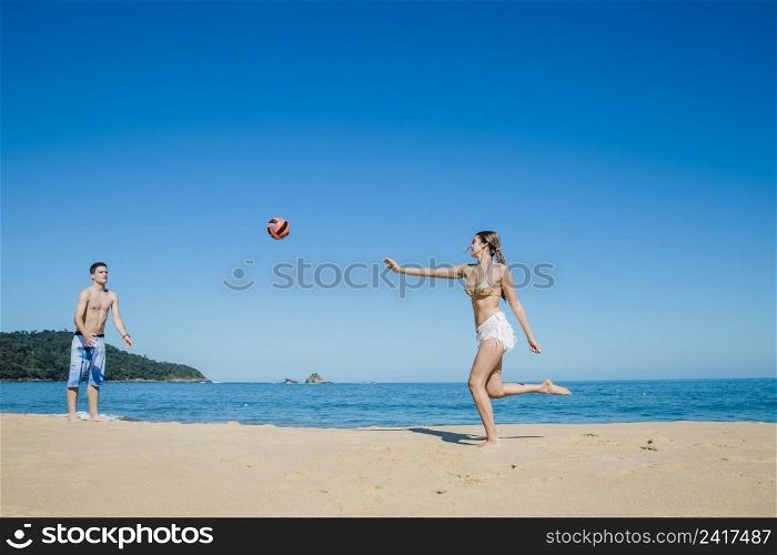 couple playing beach volleyball