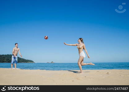 couple playing beach volleyball