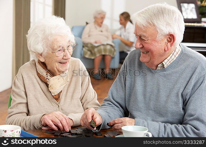 Couple Playing Dominoes At Day Care Centre