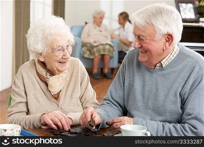 Couple Playing Dominoes At Day Care Centre