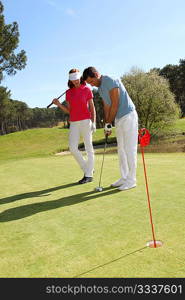 Couple playing golf on a sunny day