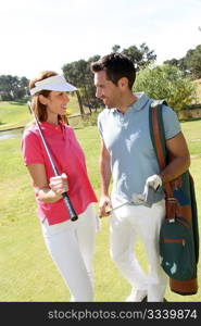 Couple playing golf on a sunny day