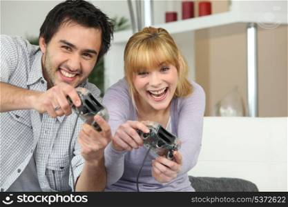 couple playing video games at home