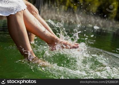 couple playing with their feet water
